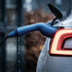 Close-up of rain falling on a blue Voldt® charging plug in an electric car socket