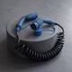 Coiled Type 2 EV charging cable resting on a round concrete pedestal