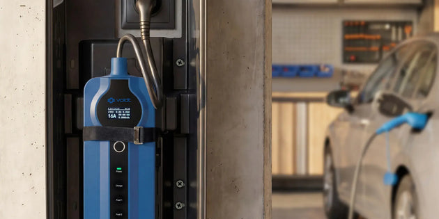 Voldt® Household Charger Box on a garage wall next to a charging electric car